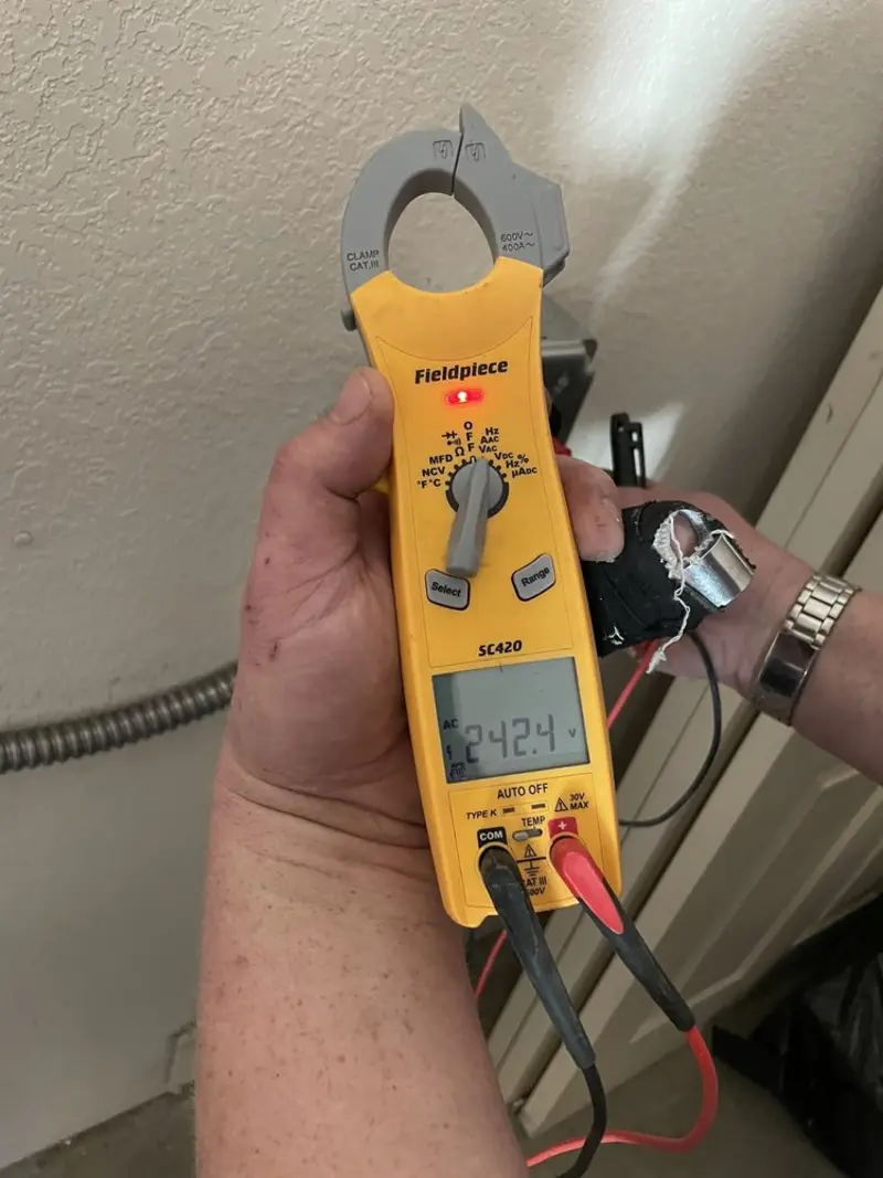 Voltage testing with clamp meter during Ceiling Fan Installation in Newman